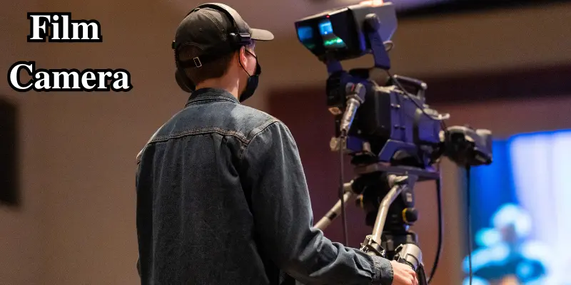 Film Camera Operated By A Crew Member In A Studio, Capturing Footage For A Production.