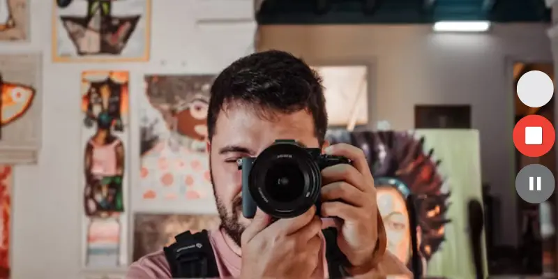 A Person Holding A Camera In A Creative Studio Setting, With Recording Buttons Visible On The Screen, Symbolizing A Webcam Test Or Camera Usage.