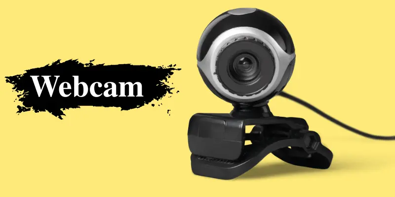 A Black Usb Webcam Placed On A Yellow Background With The Word “Webcam” Written Beside It, Showing A Clear View Of The Camera Lens And Design.